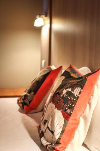 two pillows sitting on top of a bed at Hotel Agur Deneri in Ciboure