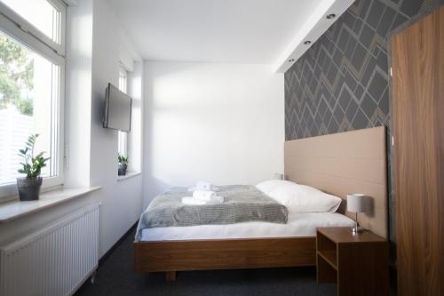 a bedroom with a bed and a large window at N°50 in Poznań