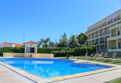 a swimming pool in front of a building at Hotel Horta in Horta