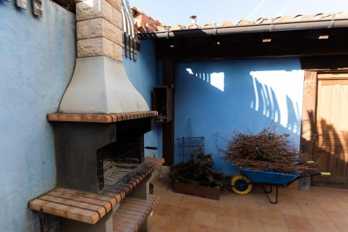 a patio with an outdoor fireplace in a house at La Casa Azul in Alcanadre