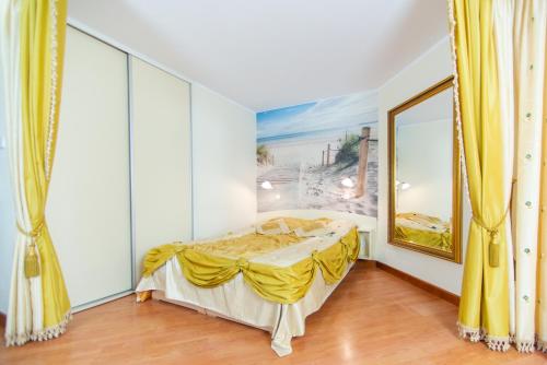 a bedroom with a bed and a painting on the wall at Apartament blisko plaży in Władysławowo