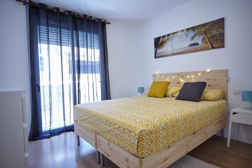 a bedroom with a bed and a large window at Apartamento Sol y Mar I in Las Galletas