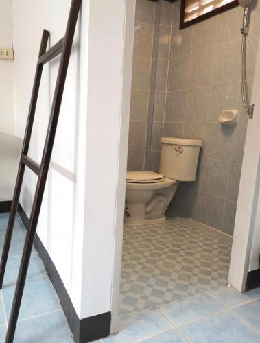 a bathroom with a toilet and a ladder at RoongThoeng Place Hotel in Thoeng