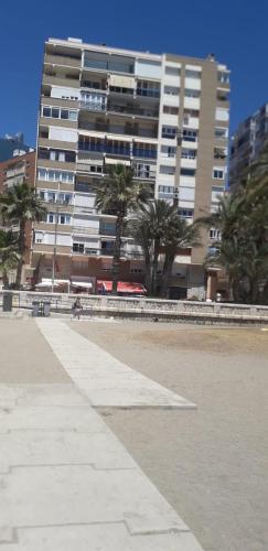 a large building with palm trees in front of it at EVE Malagueta in Málaga