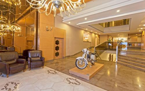 a salon with a motorcycle on a table and chairs at Xperia Saray Beach Hotel in Alanya