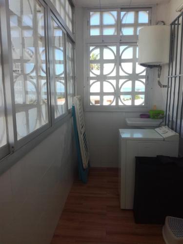 a bathroom with a sink and windows in a room at BUNGALOW CHARO in Torre de Benagalbón