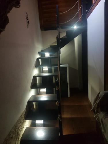 a set of stairs in a room with lights at Casa etna in Bronte
