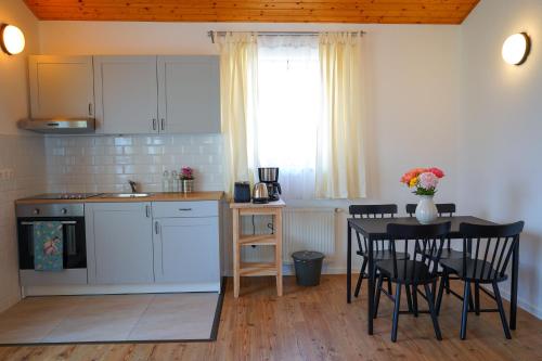 a kitchen and dining room with a table and chairs at Buda Side in Budakeszi