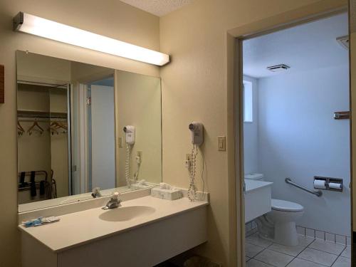 a bathroom with a sink and a mirror and a phone at Great Western Colorado Lodge in Salida