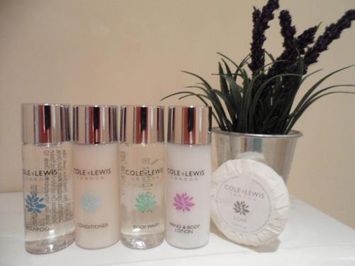 a group of four products sitting on a shelf with a plant at The Stables - Deer Park Farm in Solihull