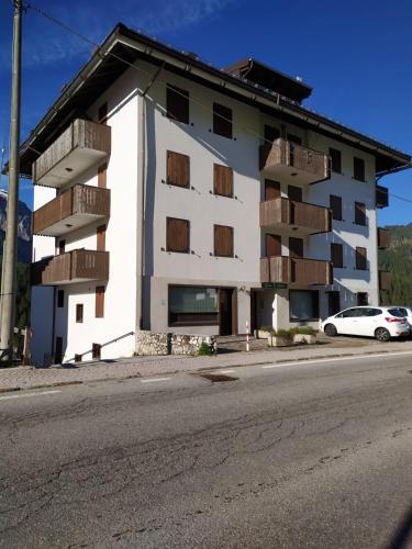 a building with balconies on the side of a street at Plodn House in Sappada