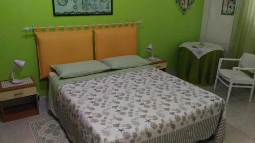 a bedroom with a bed and a table and a chair at B&b Margherita in Calasetta
