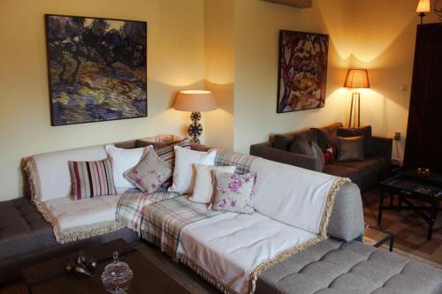 a living room with a white couch with pillows at Agape in Kala Nera