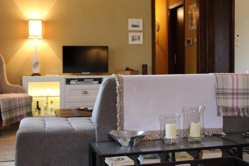 a living room with a couch and a table with candles at Agape in Kala Nera