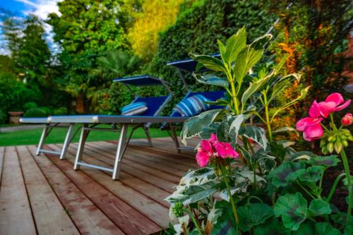 a ping pong table on a wooden deck with flowers at Villa Le Facezie B&B in Terranuova Bracciolini