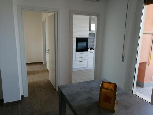 a living room with a table and a kitchen at Appartamento fronte mare in Porto Recanati