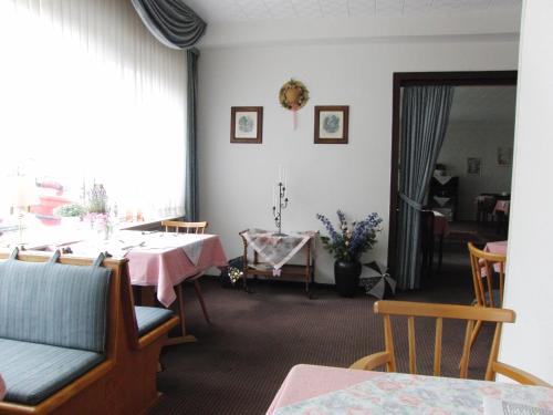ein Esszimmer mit einem Tisch und einem Fenster in der Unterkunft Hotel Olympia in Bad Orb
