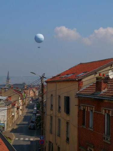 a helicopter is flying over a city with buildings at Groom Epernay - Jacuzzi & Champagne in Épernay