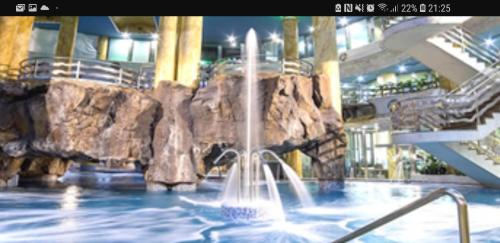 a water fountain in a swimming pool in a building at primera linea acapulco III in Oropesa del Mar