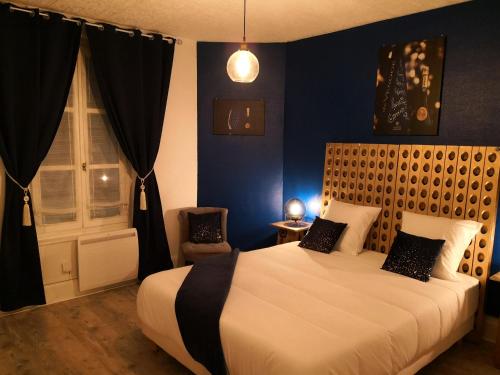 a bedroom with a large bed and a window at Groom Epernay - Jacuzzi & Champagne in Épernay
