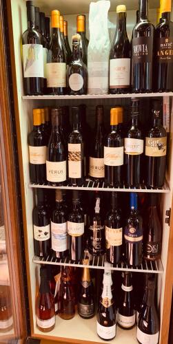 a refrigerator filled with lots of bottles of wine at Kunstelj Pension in Radovljica