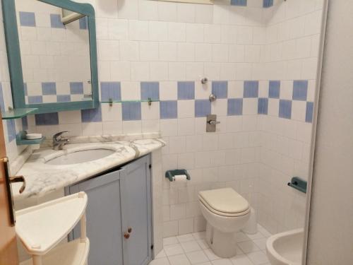 a bathroom with a sink and a toilet and a mirror at Casa Esperanto in Favignana