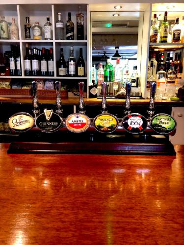 a bar with a bunch of bottles of alcohol at The George at Nunney in Frome