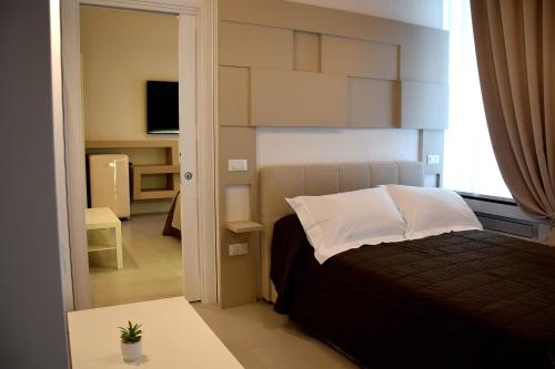 a small bedroom with a bed and a window at Le Suite del Duomo in Cava deʼ Tirreni