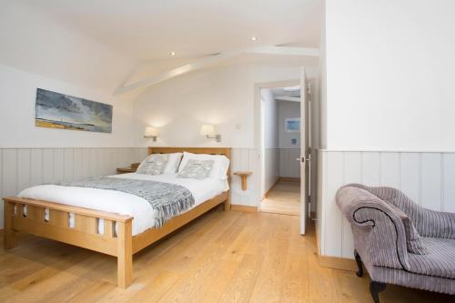 a bedroom with a bed and a chair at Hotel Continental in Whitstable