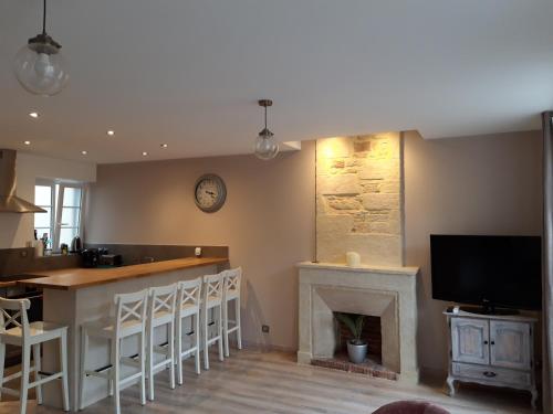 un salon avec une cheminée et une télévision dans l'établissement Appartement centre-ville Bayeux, tout à pied !, à Bayeux