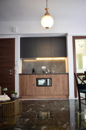 a kitchen with a sink and a microwave at Beach Side Apart II in Kavala