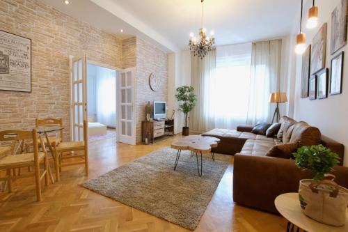 a living room with a couch and a table at Standard Apartment by Hi5 - Madách Imre 1 in Budapest