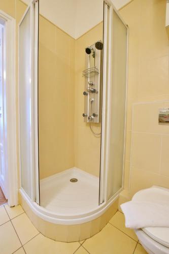 a bathroom with a shower and a toilet at Standard Apartment by Hi5 - Madách Imre 1 in Budapest