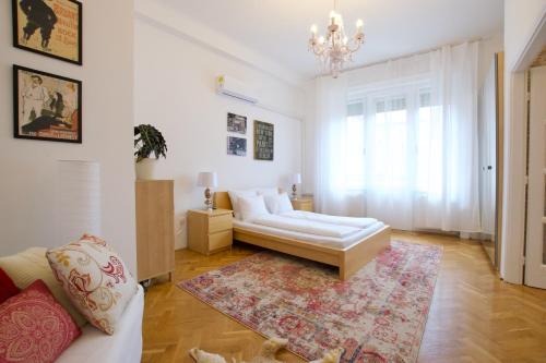 a living room with a couch and a rug at Standard Apartment by Hi5 - Madách Imre 1 in Budapest