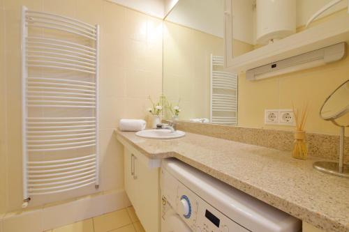 a bathroom with a sink and a mirror at Standard Apartment by Hi5 - Madách Imre 1 in Budapest