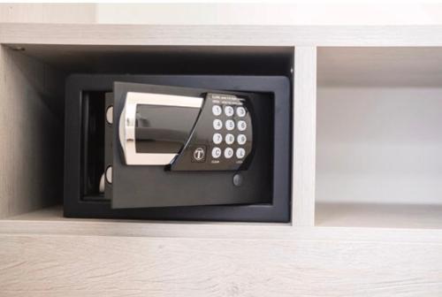 a microwave oven with a phone in a cabinet at Imera B&B in Favignana