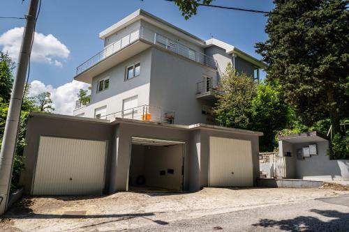 a white house with a garage in front of it at Sweet Secret in Samobor