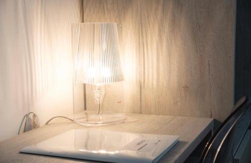 a desk with a lamp and a laptop on it at Imera B&B in Favignana
