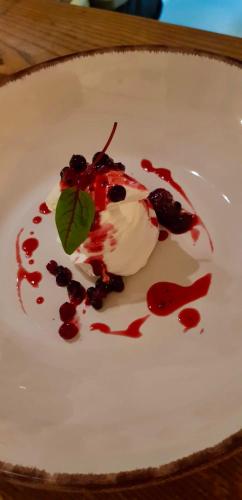 a white plate with a dessert on a table at The George at Nunney in Frome