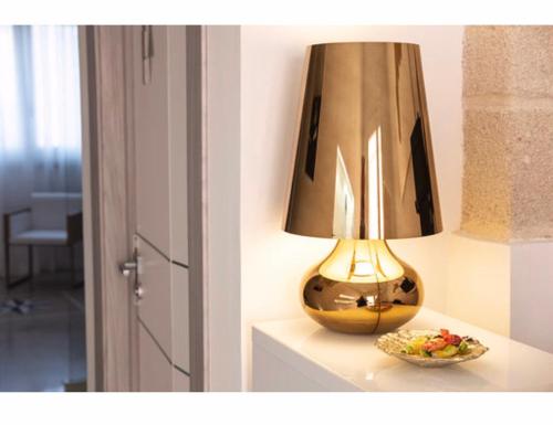 a lamp sitting on a table next to a bowl of food at Imera B&B in Favignana