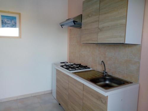 a kitchen with a sink and a stove at Torre del Lago in Foce Varano