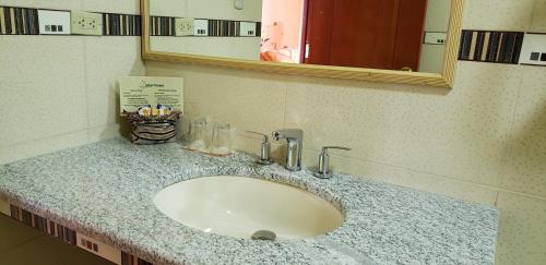 a bathroom counter with a sink and a mirror at Morales Guest House in Huaraz