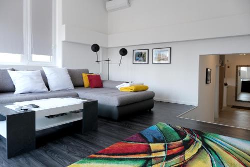 a living room with a couch and a coffee table at Main Square Oval Apartment in Zagreb