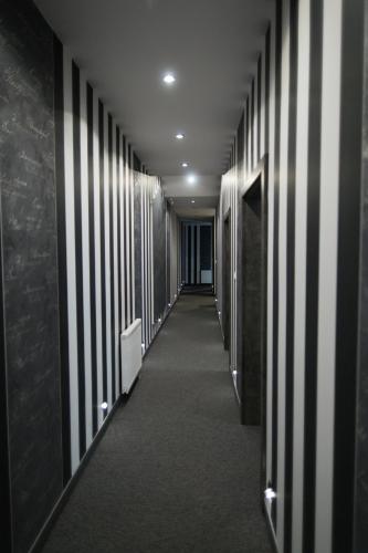 a hallway with black and white stripes on the walls at N°50 in Poznań
