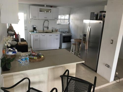 a kitchen with a counter and a refrigerator at El Yunque White House in Rio Grande