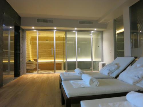 a living room with two white couches and a glass door at Quinta Vale da Roca in Sintra