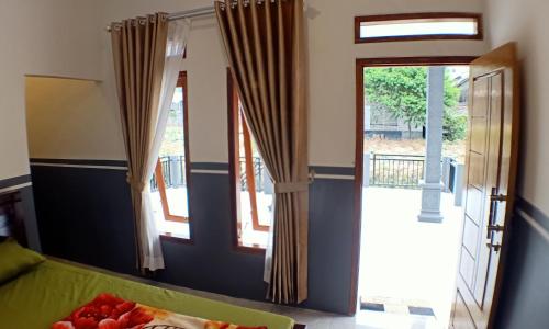 a room with a table with a plate of fruit on it at Homestay Anggun Bromo in Bromo