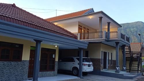 a white car parked in front of a house at Homestay Anggun Bromo in Bromo