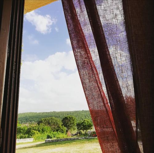 a window with a view of a field at Trulli Panoramici in Alberobello