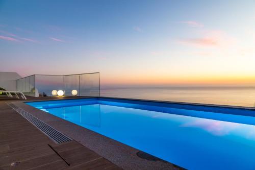 a swimming pool on the roof of a house at A&M House II Luxury Holidays Home in Arco da Calheta